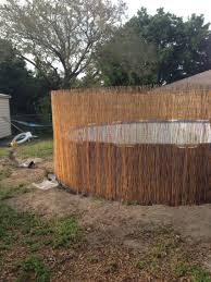 Cheap And Easy Safty Fence Around A Above Ground Pool Just Get Chicken Wire And Bamboo Fence From L Above Ground Pool Landscaping Above Ground Pool Pool Fence