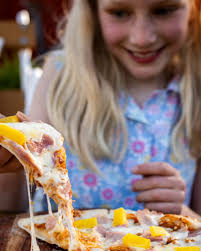 Our cozy spot is the perfect place to keep the whole family happy. While  the kids dive into delicious, cheesy pizzas, you can sit back, unwind and  enjoy a drink (or two—we