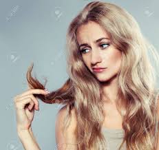 Beautiful girl holding her hair in hand. Young Woman Looking At Split Ends Damaged Long Hair Stock Photo Picture And Royalty Free Image Image 20707474
