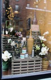 Crystal City Olive Oil Spring Window Display Tuscan Inspired Elements With Spring Florals Corning S Tuscan Design Tuscan Decorating Spring Window Display