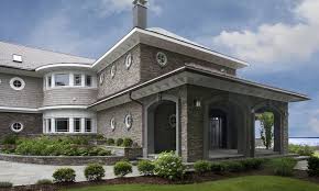 Bright colored turquoise blue entry door on a dark graphite shiplap and stone contemporary. Stacked Stone Eldorado Stone