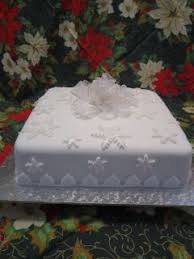It may seem challenging, but it's not as hard as you might think. This Is A 9 Square Fruit Cake Covered In Marzipan And Fondant Fondant Snowflakes And An Organza Bow For Christmas Cake Decorations Cake Decorating Fruit Cake