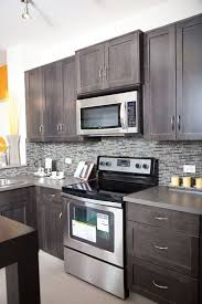 This black kitchen boasts all stainless steel finishes, with metal barstools and grey countertops to complete the look. Pin By Berenice Cobos On We Create Kitchens Kitchen Design Kitchen Remodel Kitchen Cabinets