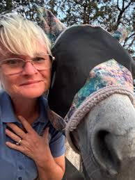 Hand carved carousel horses with We Farm ear of corn