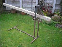 You can run a cable (or clothesline) thru the bottom hem and attaching to dog tie out stakes into the ground or attach to your floor. Cantilever Log Holder Mig Welding Forum