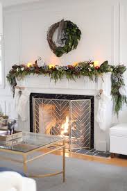To complete the look, a collection of small houses peek out above a lush christmas mantel garland with eucalyptus, pinecones, and small berries. How To Hang Garland On A Mantle Or Mantel Rambling Renovators