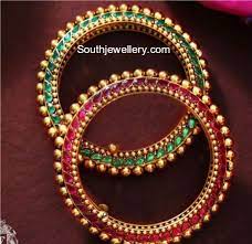 22 Carat Gold Bangles Studded With Rubies On One Side And Emerald On The Other Side By Talwar Jewellers Two S Bridal Jewelry Gold Bangles Gold Bangles Design