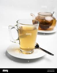 Glass Of Tea And Teapot The Tea Bag Can Be Seen In The Pot Stock Photo Alamy
