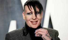 In this photo, he removed all his makeup, no cream, no mascara or lipstick.manson wears a black polo shirt and a completely natural hairstyle with the side turn and golden light brown color.he is like an ordinary man in this situation because he doesn't want to be too different at any time. Marilyn Manson Faces La Sheriff Investigation After Abuse Allegations Entertainment News The Indian Express