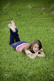 Character concert teen book video, christian teen book video, character concert. A Pretty Teenage Female Girl Laying Face Down On Green Grass Looking Thoughtful Stock Photo Picture And Royalty Free Image Image 10034168