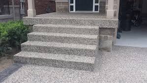 These pavers contrast nicely with the rough grey exposed aggregate. What Is Exposed Aggregate Concrete Markstone Landscaping