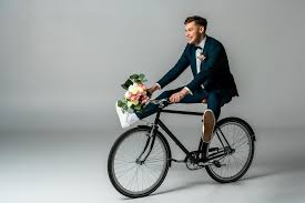 Discount taken in cart online. Happy Groom In Elegant Suit And Sneakers Riding Bike And Holding Wedding Bouquet On Grey Background Free Stock Photo And Image