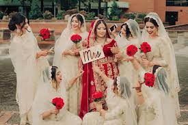 Indian Bride In Red And Gold Lehenga And Bridesmaids In Gold And White Lehengas Asian Bridal Dresses Bridesmaid Desi Wedding Dresses