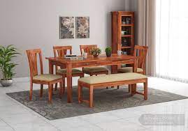 Crafted of solid malaysian oak wood, this dining table features a round tabletop with a smooth, reverse. Buy Mcbeth Storage 6 Seater Dining Table Set With Bench Honey Finish Online In India Wooden Street