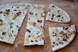 The story behind flammkuchen, or flammenkuchen, goes back to the days of wood fired bread ovens, when alsace bakers used any left over dough as a 'trial run' to gauge their. Tarte Flambee An Alsatian Pizza German Flammenkuchen Stock Photo Picture And Royalty Free Image Image 98615054