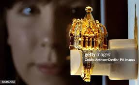Gallery assistant Beth Humphries inspects a 14th century gold Jewish...  News Photo