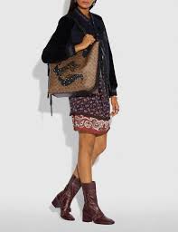 Coach medium charlie backpack with wristlet and bifold wallet. Our Tote 34 Is An Oversized Carryall With A Spacious Center Compartment For Everything You Might Need For Every Day Or Travel Crafted Of Signature Canvas It Features Supernatural Graphics Created Exclusively For Coach By Chelsea Champlain It S Detailed