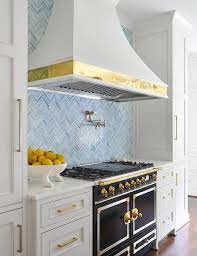 Warm blue cabinets and a coordinating backsplash bring fabulous flair to this kitchen. Light Gray Kitchen Cabinets With Blue Backsplash Tiles Transitional Kitchen