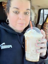 Iced turtle latte with whipped cream and chocolate drizzle