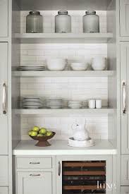 Grey Kitchen Features Stacked Gray Floating Shelves Over A Built In Wine Cooler Which Is Flanked By Dual Refri Taupe Kitchen Open Shelving Kitchen Inspirations