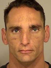 Man charged with murder in inmate's killing; pleads not guilty