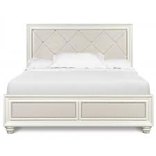 Coordinate your bedroom set with a luxurious leatherette upholstery and brushed nickel hardware, then keep your space tidy with ample storage in the nightstand and under the bed frame. Magnussen Furniture Diamond Island Bedroom Set In Pearlized White
