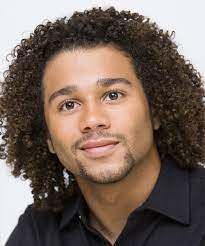 Actually all through school he got straight as. Corbin Bleu Medium Curly Afro Hairstyle