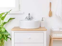 Wooden unit with a sink, toilet and a storage compartment a basin and a toilet combined and clad with grey wood A Small Bathroom Needs The Right Sink