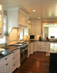 With an enclosed galley kitchen with no windows, however, dark floors may make the space feel too closed for some people. 30 Spectacular White Kitchens With Dark Wood Floors Kitchen Remodel Off White Kitchens Kitchen Design