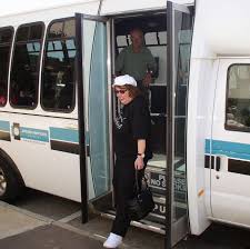 A photo of one of our museum founders, Doris Rollins Cannon, off boarding a  bus after a Heritage Tour! Heritage Tours have been an offering of the  museum for over two decades.