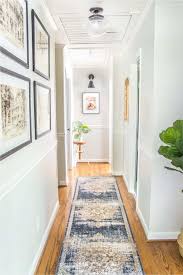 The different size and paneling on the doors along with one wall being brick and there being a wood art piece above the middle door draws attention to all of the doors. 6 Tips To Decorate A Boring Hallway In 2021 Narrow Hallway Decorating Hallway Wall Decor Small Hallways