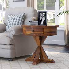 Pick up this teakwood creation that uses branches as legs. Floreo Rustic Solid Wood Round End Table With Drawer