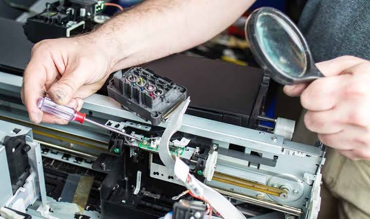 Technician Fixing Printer