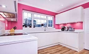 Pink color, honeysuckle pink color for interior decorating. Modern Kitchen With Pink Walls And Hardwood Flooring It Includes White Cabinetry With Built In Lights And Marb Pink Kitchen Modern Pink Kitchen Purple Kitchen