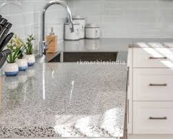 The white island with a dark gray granite countertop is decorated with white and gray patterns of the patterned floor tile. Pearl White Granite Buy Granite Online Rk Marbles India
