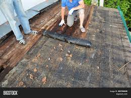That said, pros say a new roof should never be installed over wet wood or a wrinkled barrier. Roofers Roof Repair Image Photo Free Trial Bigstock