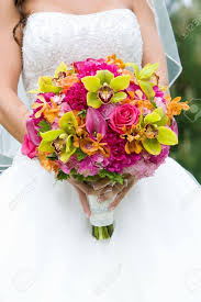 This color palette is perfect for spring and summer weddings. Wedding Bouquet Of Flowers Held By A Bride Pink Orange And Green Stock Photo Picture And Royalty Free Image Image 12820575