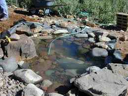 Put the preformed liner into the hole for the waterfall pond. How To Create A Pond And Stream For An Outdoor Waterfall How Tos Diy