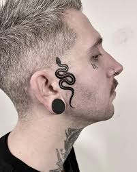 SNAKE&DAGGER Face bangers for the super @jay.edge Did at  @tattooloungehelsinki . DM for info and appointments ─ ─ ─ ─ ─ ─ ─  #blackwork #tattoocomo #tattoohelsinki #blackink #art #facetattoo  #snaketattoo #daggertattoo