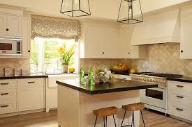 Cream Kitchen Features Cream Shaker Cabinets Paired With Black Marble Countertops And A Cream Black And Cream Kitchen Cream Shaker Kitchen White Kitchen Tiles