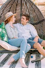 Young couple starts in the swinger world with another couple. Young Couple Enjoy Time Together While Sitting Outside On A Wicker Swing Chair By Rzcreative At Home Couple Stocksy United