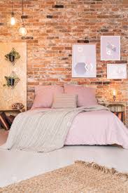 The exposed brick wall gives the living room a lot of character already, which is enhanced by the contrasting black and white kitchen. Modern Bedroom With Double Bed Pink Bedding And Brick Wall Stock Photo Picture And Royalty Free Image Image 71353739
