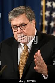 Attorney General William Barr speaks with Bill Dial, chief of the  Whitefish, Mont., Police Department, as he poses for photos after speaking  at a law enforcement roundtable at the Flathead County Sheriff's