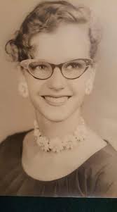 Can you identify others in the photo with bangs and glasses?