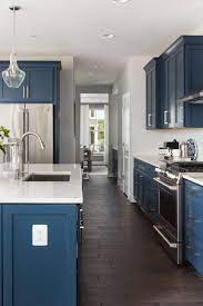 Shaker Blue Cabinetry White Quartz Countertops Subway Tile Backsplash Dark Laminate Wood Floor Blue Kitchen Cabinets Grey Kitchen Floor Kitchen Cabinet Styles