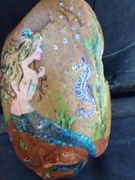 The words were found daubed in red and white on the rock the mermaid sits on. 39 Mermaids Painted On Rocks Ideas In 2021 Painted Rocks Stone Painting Rock Art