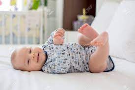 Cute Little Smiling Newborn Baby Boy Playing In Bed In The Morning Stock Photo Picture And Royalty Free Image Image 91295516