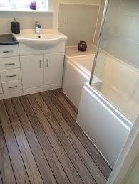 This White Bathroom Furniture Looks Great Alongside The Wooden Laminate Flooring White Bathroom Furniture Small Bathroom Remodel Designs Small Bathroom