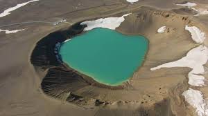 Krafla Caldera and Turquoise Lake. Volcanic Crater. Iceland. Aerial View.  Drone Flies Forward, Tilt Down