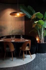 Vases And Plants Are Used Here Together With The Textiles And The Wooden Chairs To Absorb Restaurant Interior Design Restaurant Interior Bar Interior Design